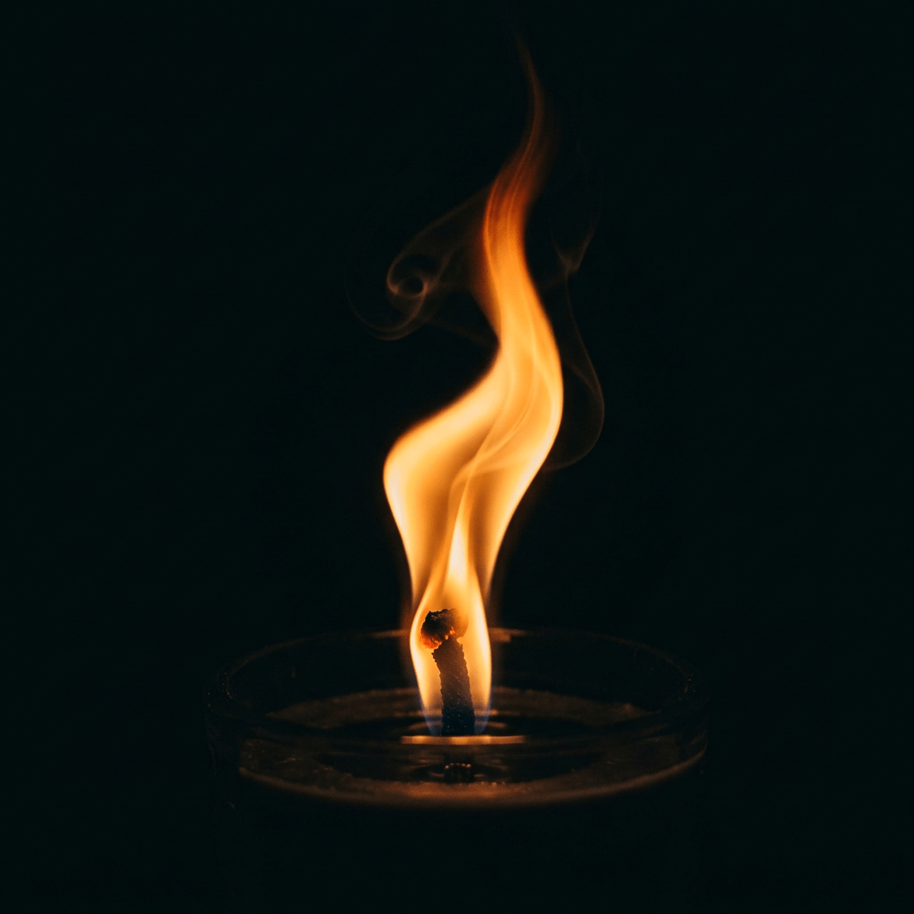 Bright orange candle flame with visible wick and glowing tip